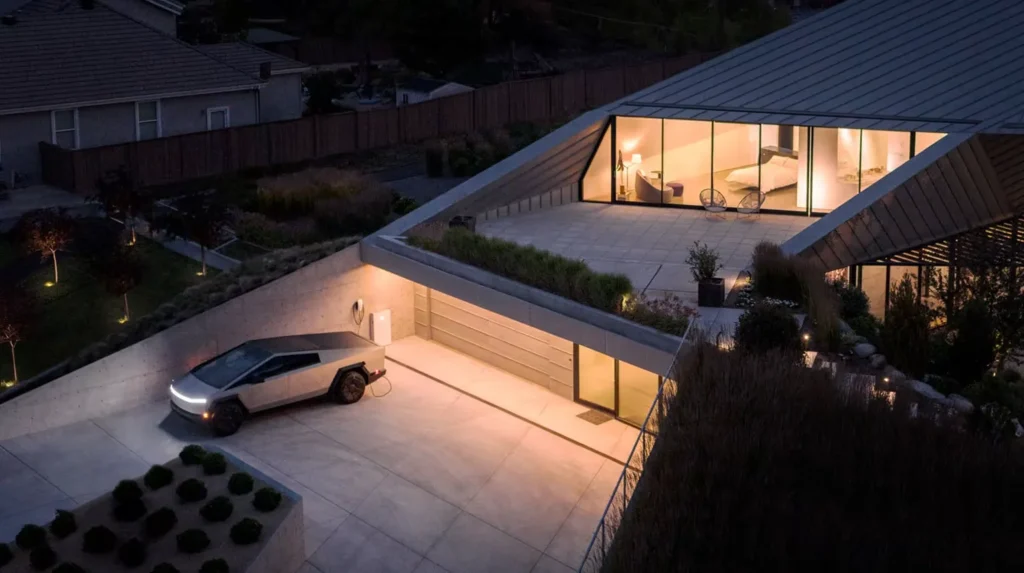 Modern house with nighttime lighting and electric vehicle