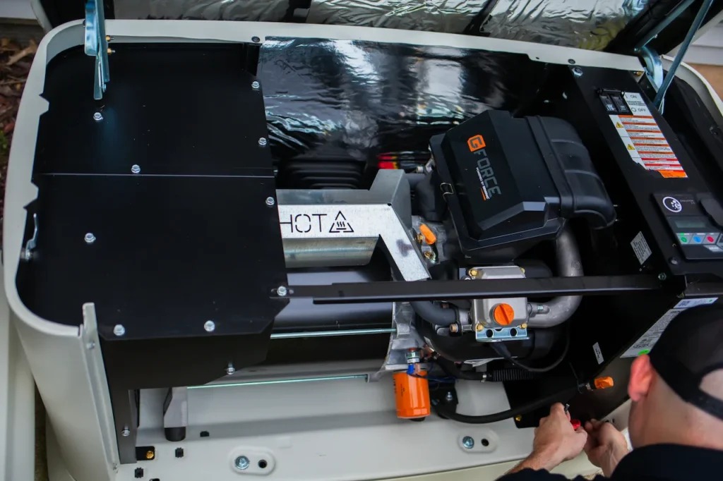 Technician working on a residential generator engine.