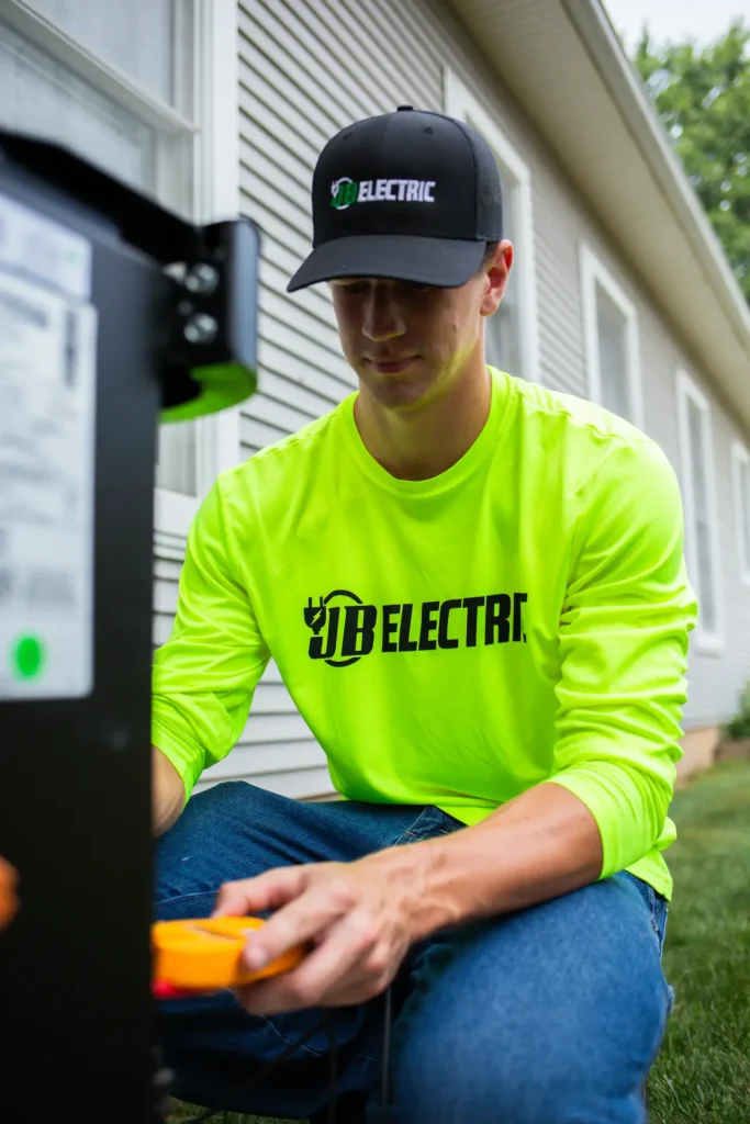 Electrician in neon shirt working with equipment