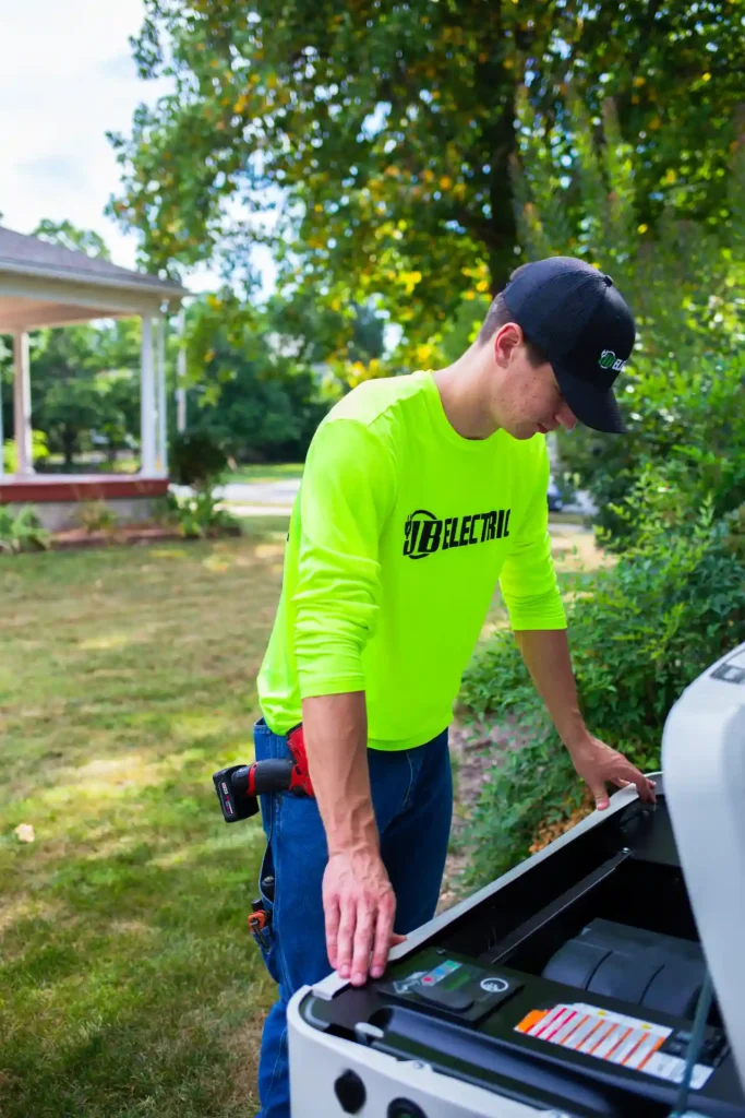 Electrician working outdoors near generator equipment.