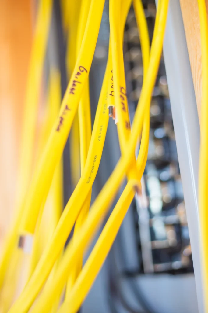 Yellow network cables in server rack.