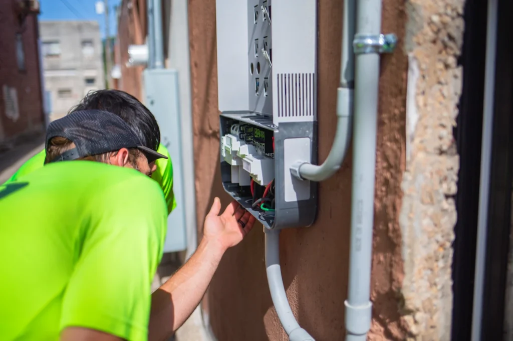 Technician inspecting outdoor telecommunications equipment