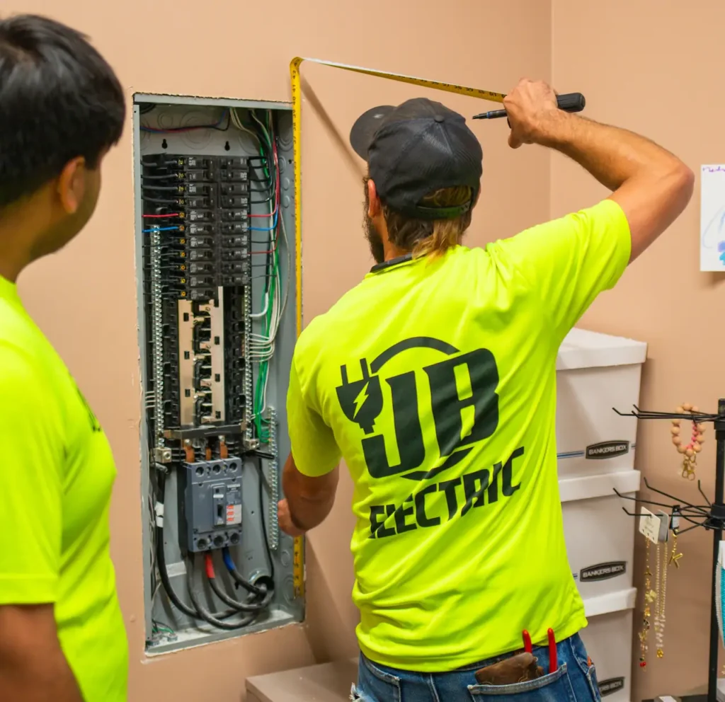 Electricians working on circuit breaker panel