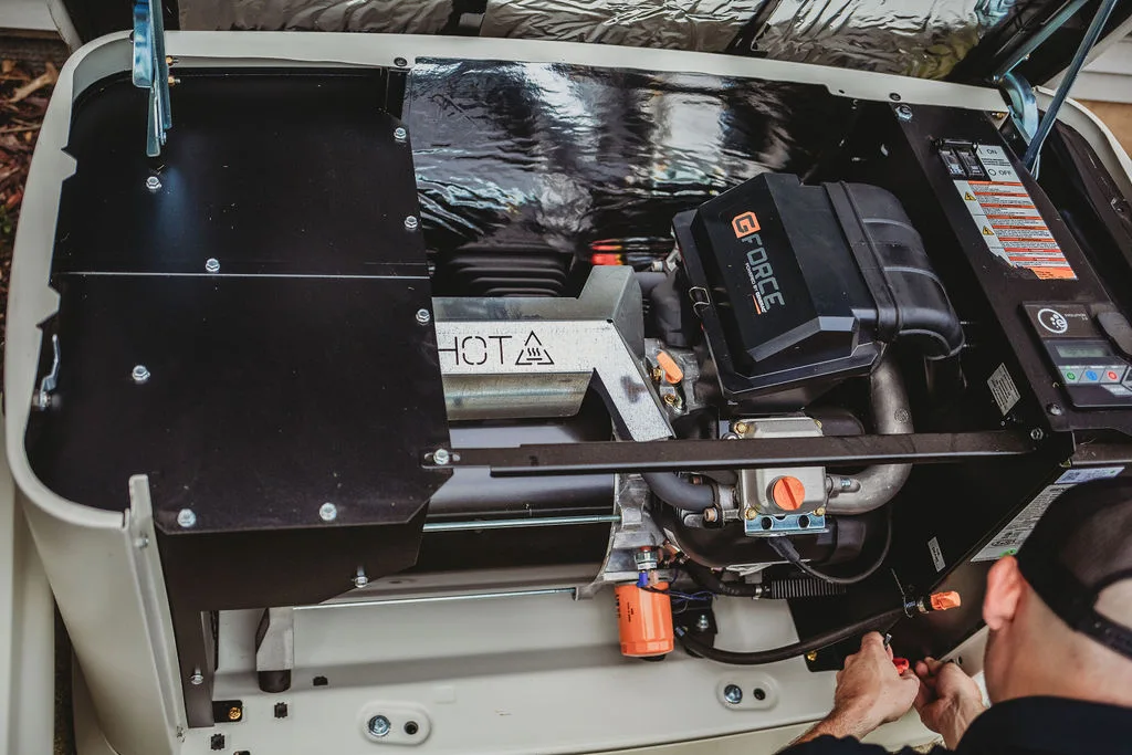 Technician working on a residential generator engine.