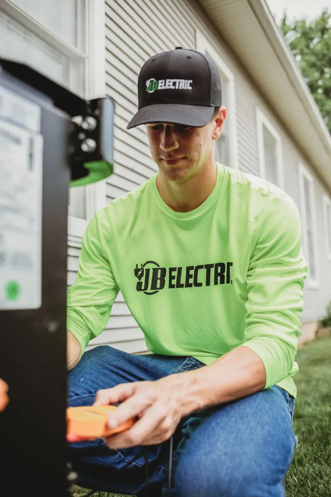 Electrician in neon shirt working with equipment