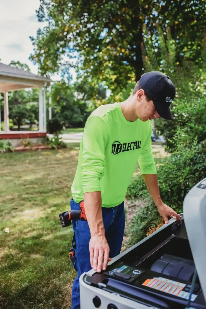 Electrician working outdoors near generator equipment.
