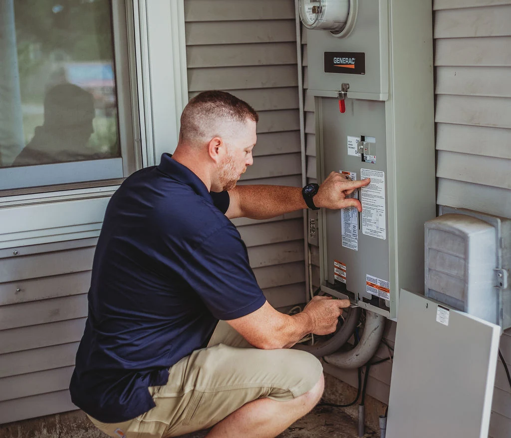 Technician inspecting home electrical generator switchboard.