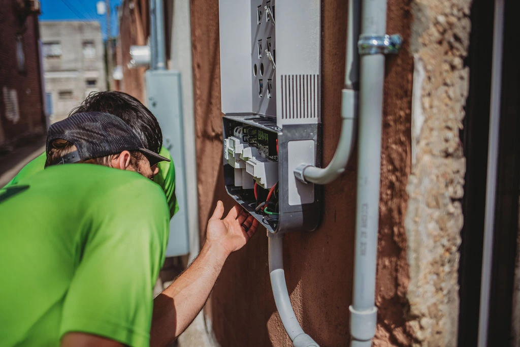 Technician inspecting outdoor telecommunications equipment