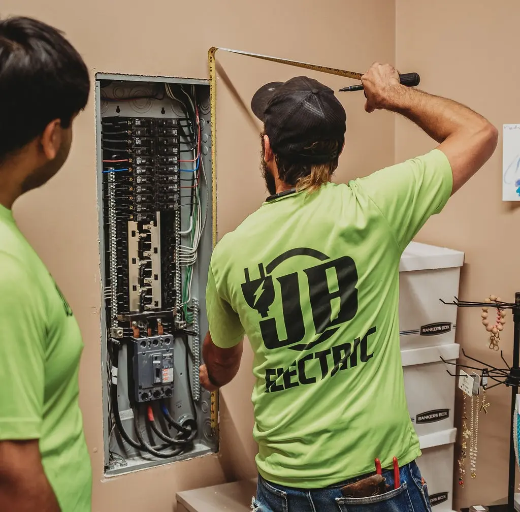 Electricians working on circuit breaker panel