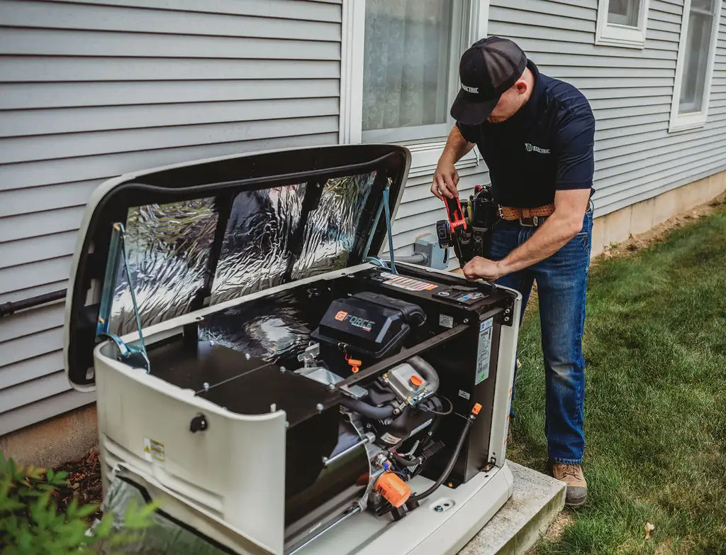 Technician repairing home generator outside house.
