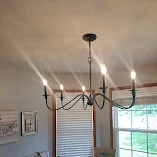 Modern chandelier with five lights in dining room.