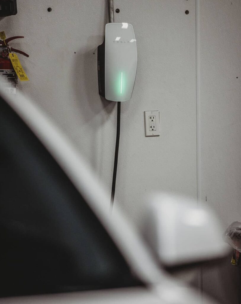 Tesla wall connector in garage.
