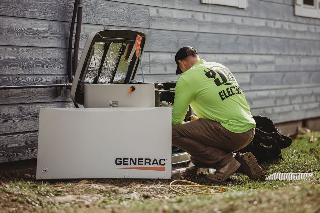 Technician working on Generac home generator installation